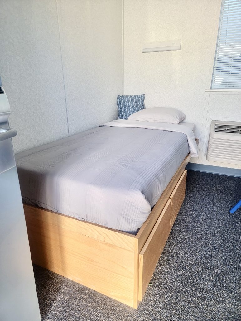 Clean dorm room, made bed