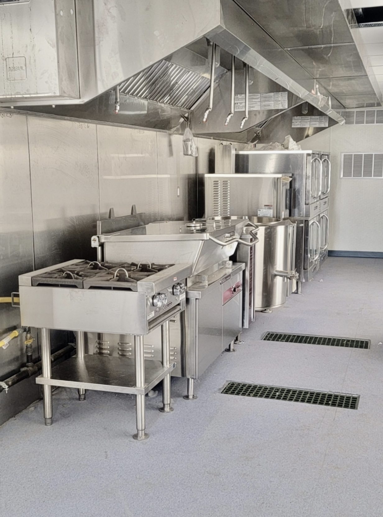 Commercial kitchen — ranges under exhaust hood