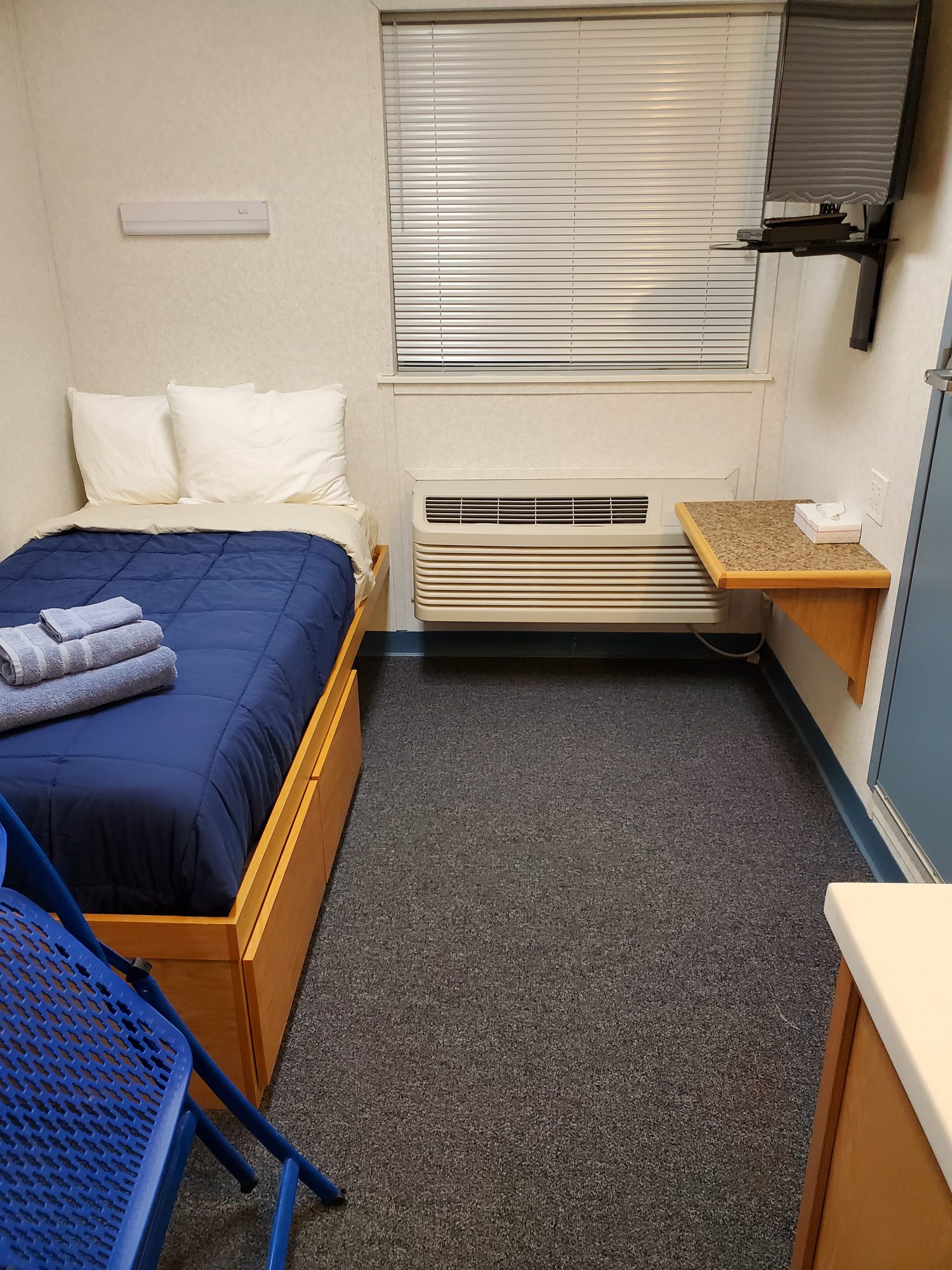 Dorm room — twin bed, desk, wardrobe